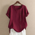 Blusa de algodón de manga corta con botones asimétricos